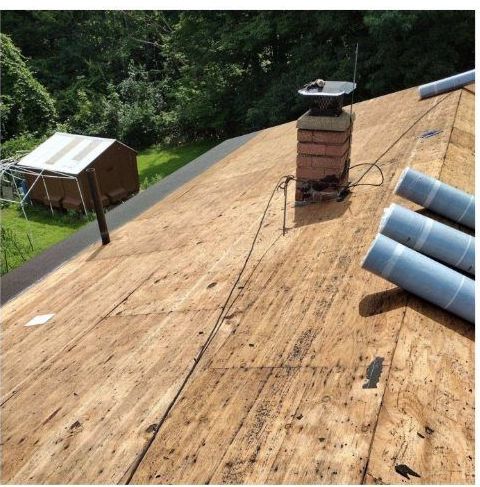 A wooden roof with a chimney on top of it