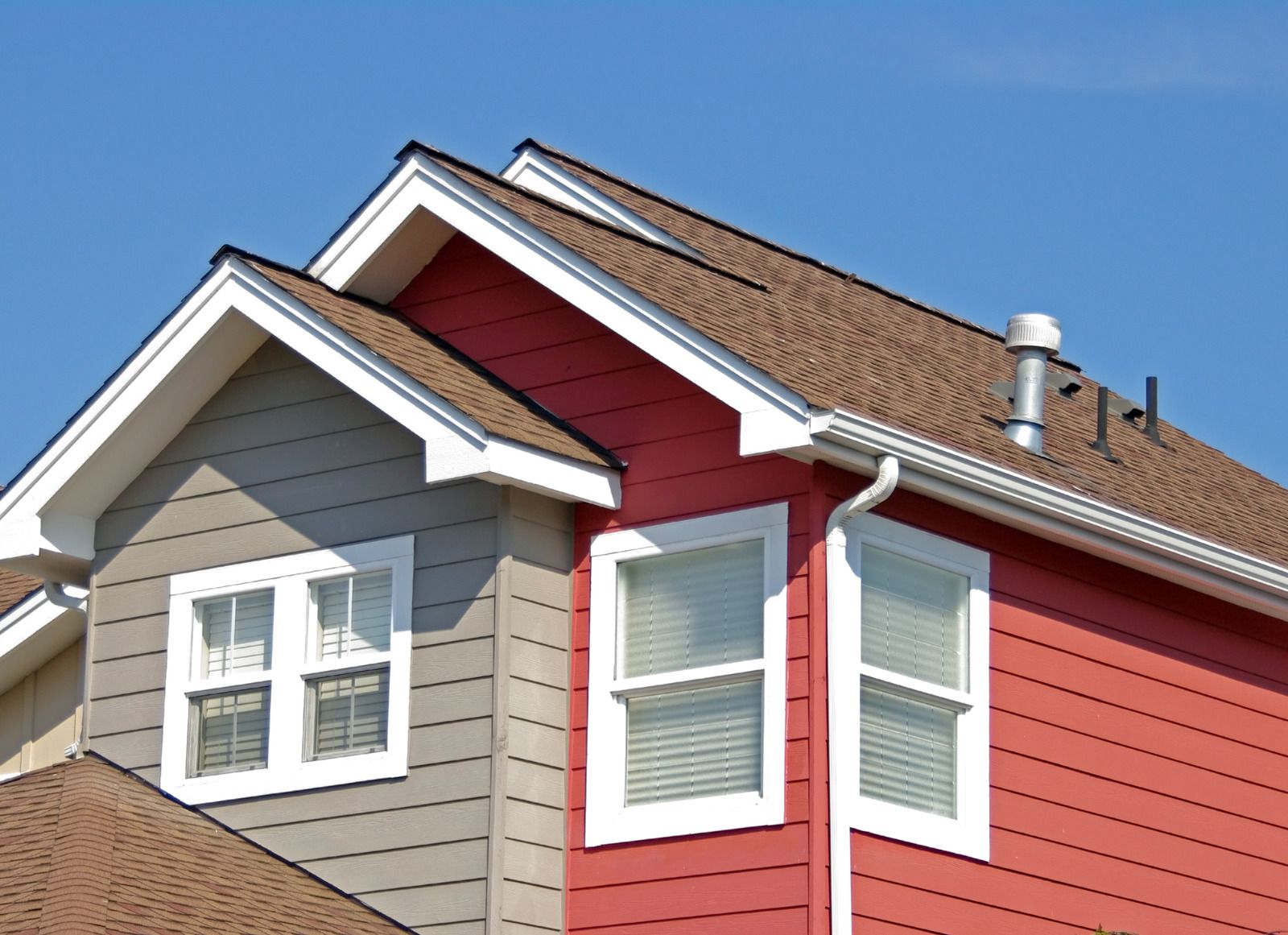 A red and gray house with a brown roof