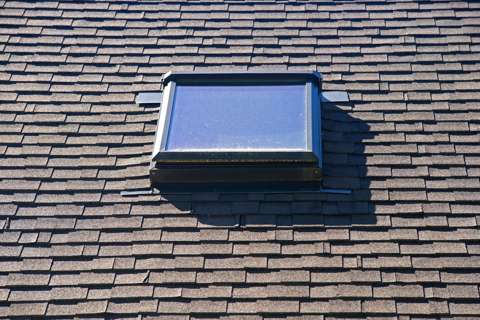 A skylight on top of a brick roof