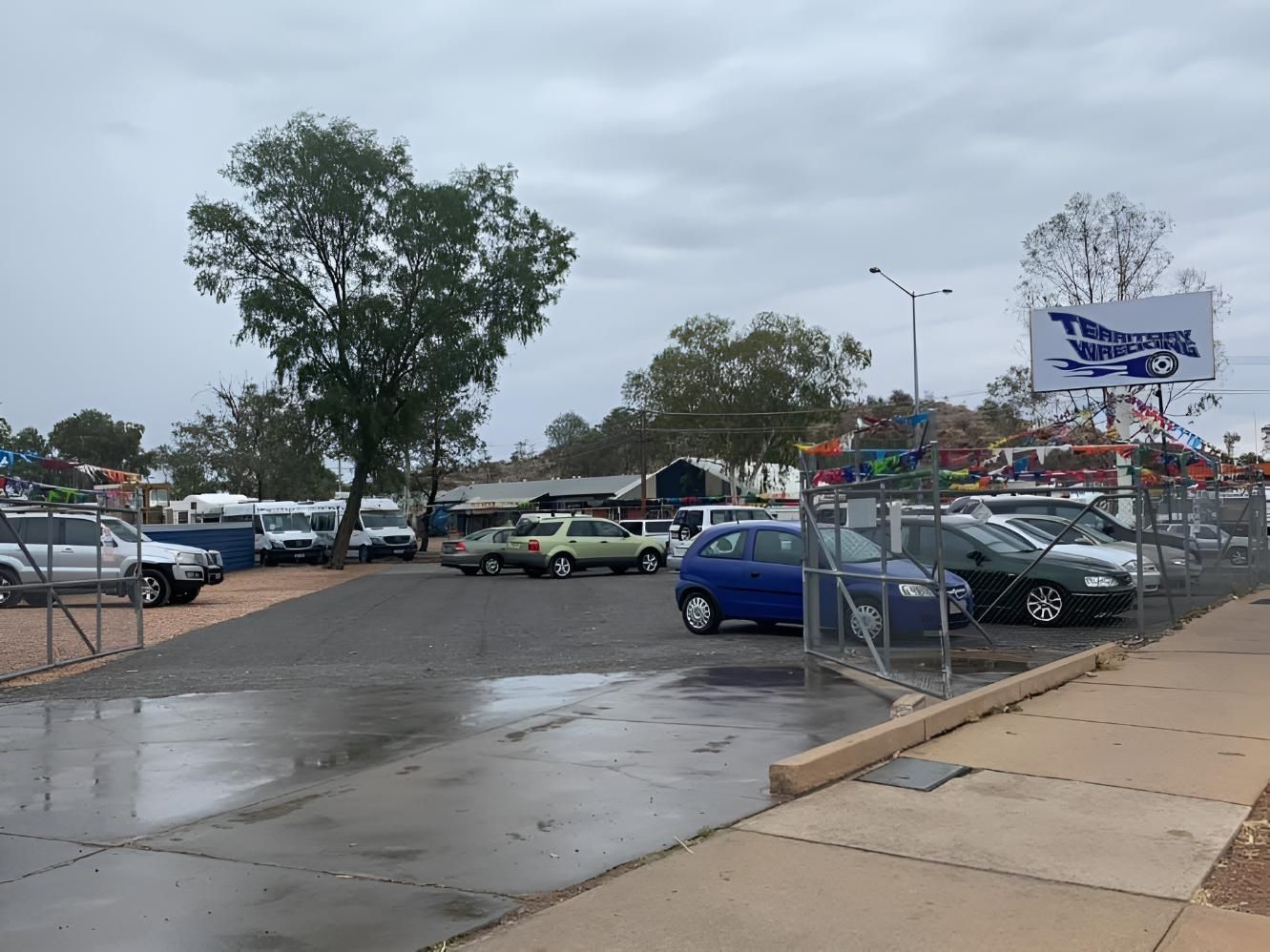 A Lot Of Cars Are Parked In A Parking Lot On A Rainy Day — Territory Wrecking Repairs In Alice Springs, NT