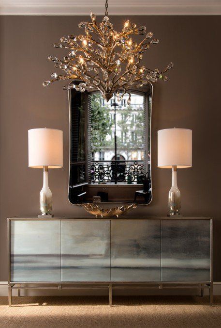 Stylish Chandelier Hung in Front of Large Mirror