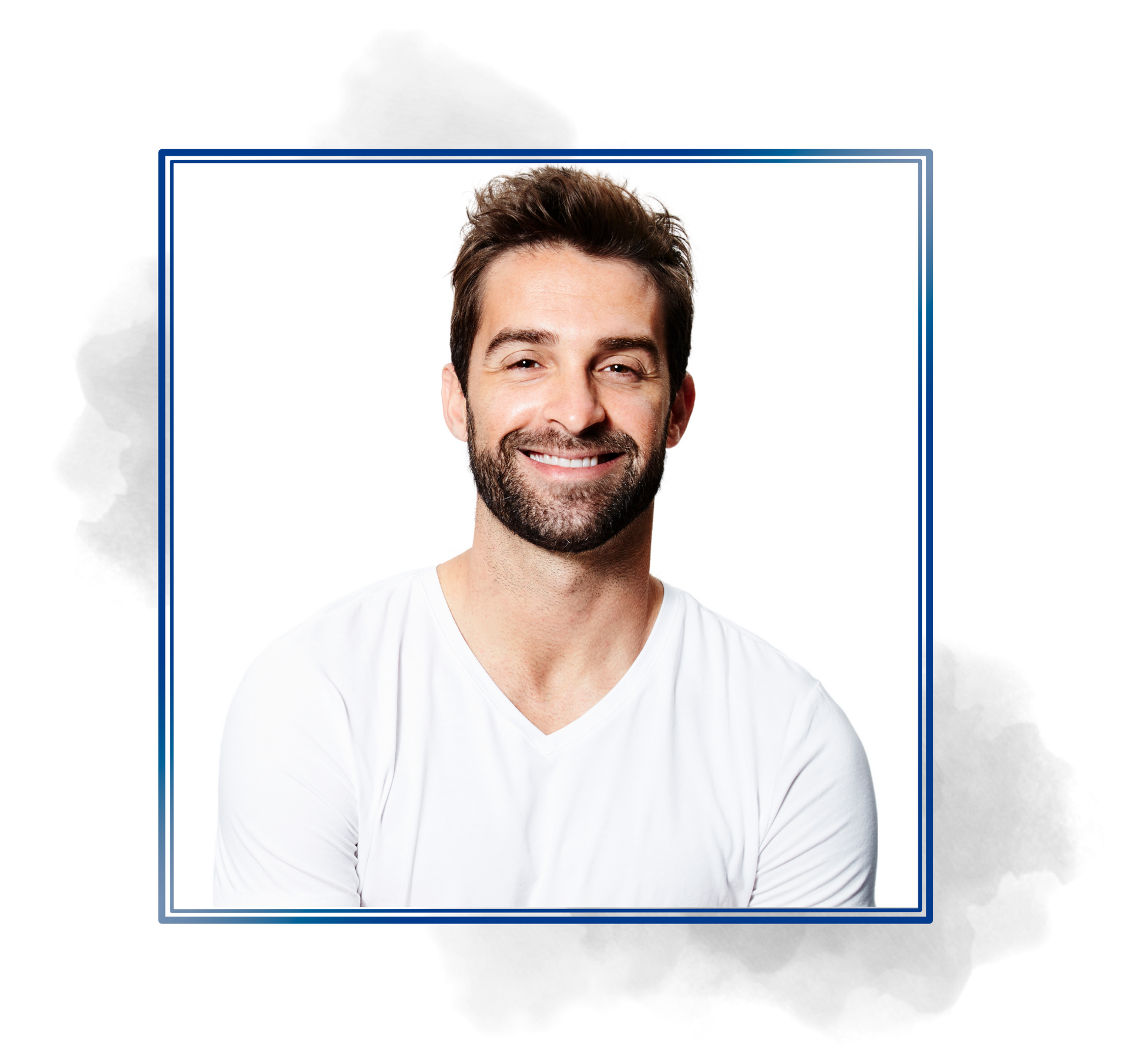 A man with a beard is wearing a white shirt and smiling.