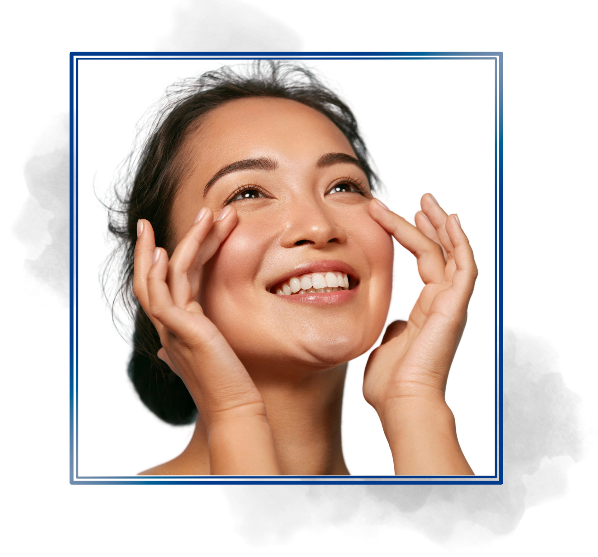 A woman is smiling and touching her face with her hands.