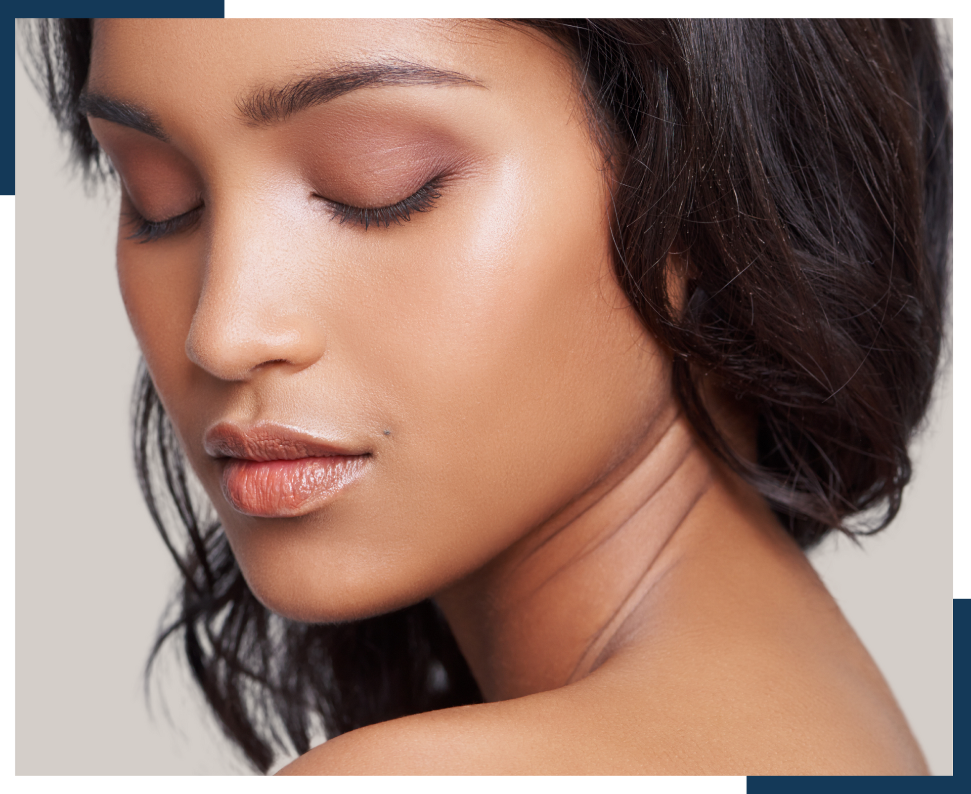 A close up of a woman 's face with her eyes closed.