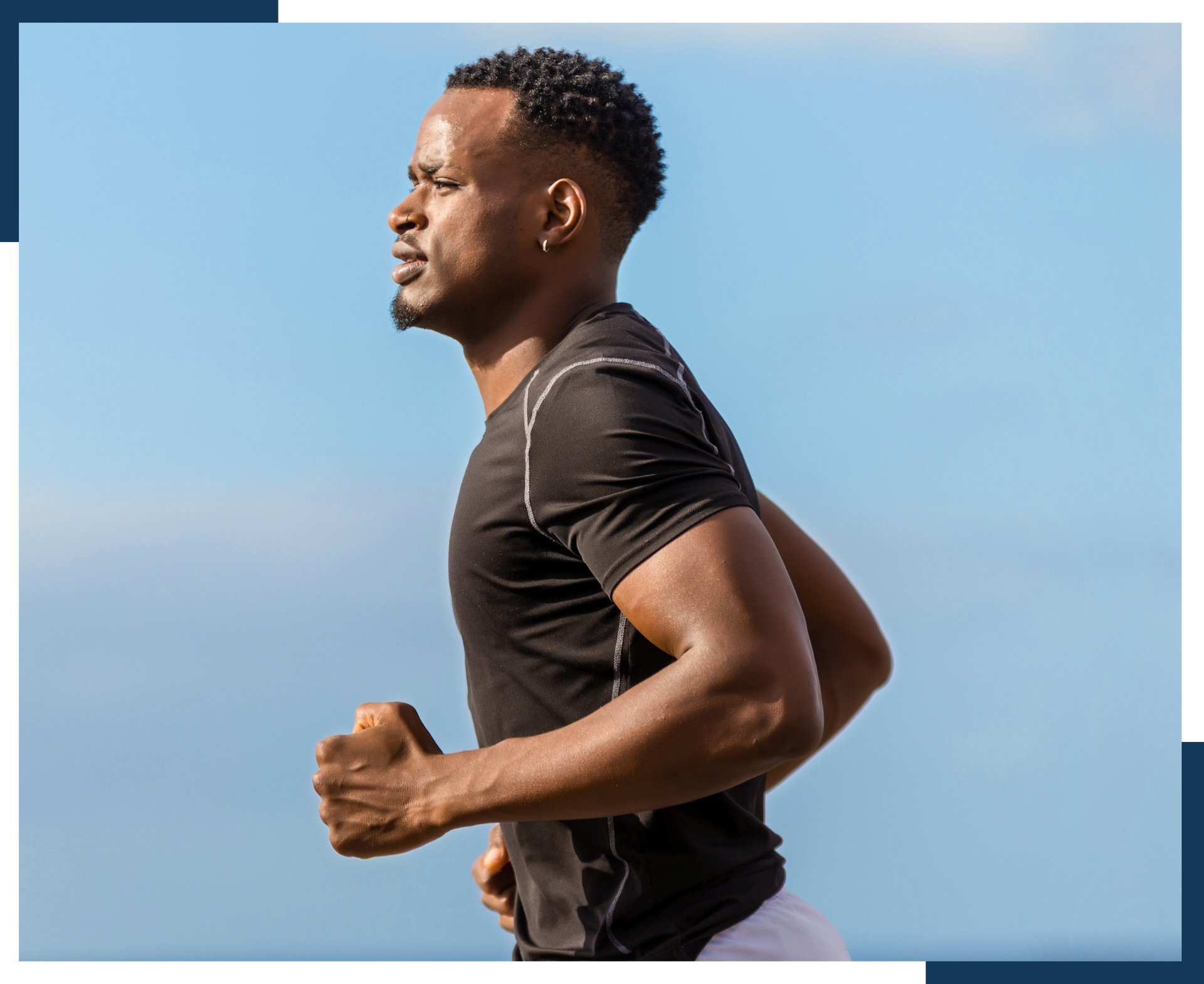 A man in a black shirt is running on a beach.