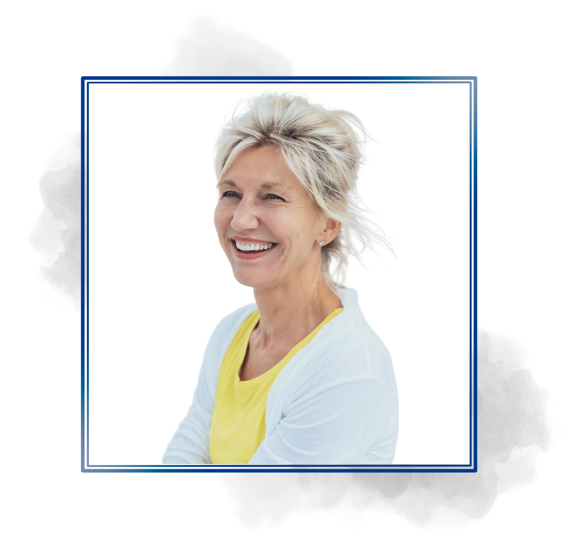 A woman in a yellow shirt and a white sweater is smiling.