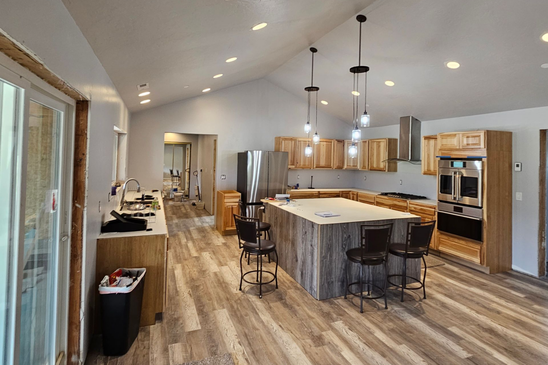 A stainless steel microwave is above a black stove