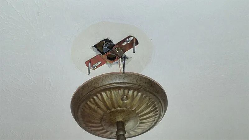 A close up of a light fixture hanging from the ceiling