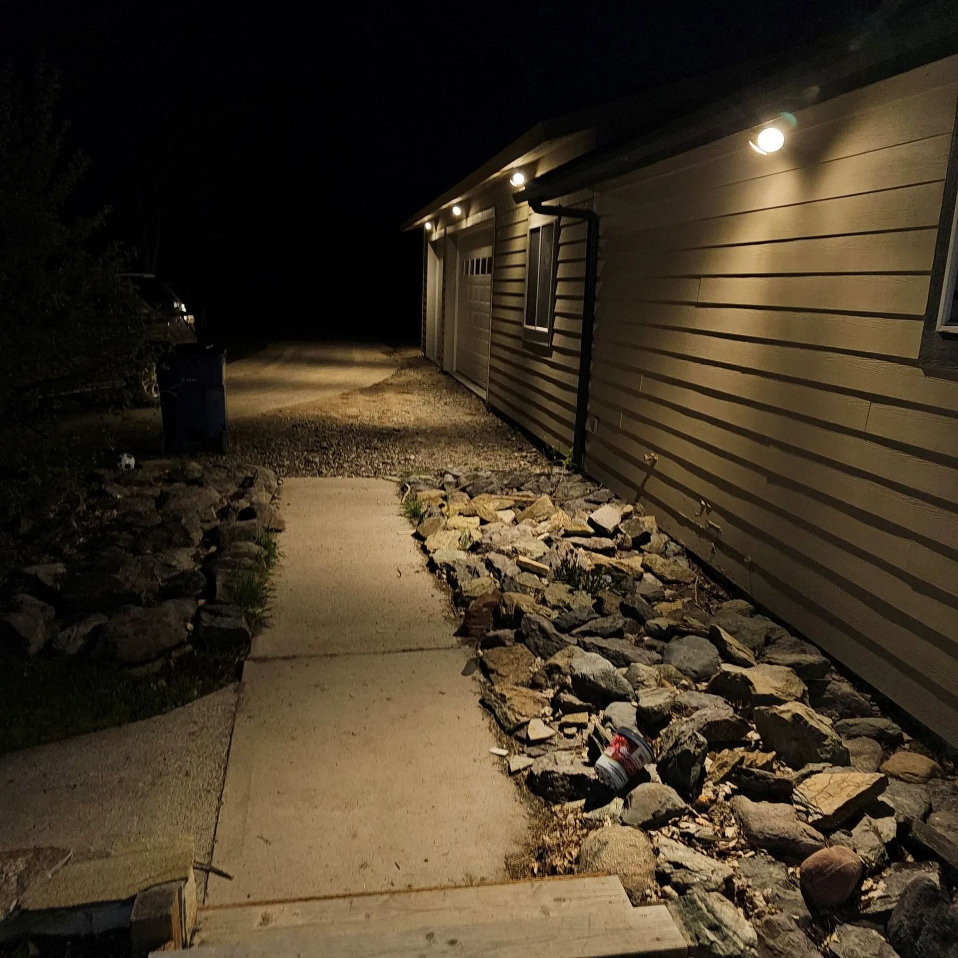 A walkway leading to a house at night