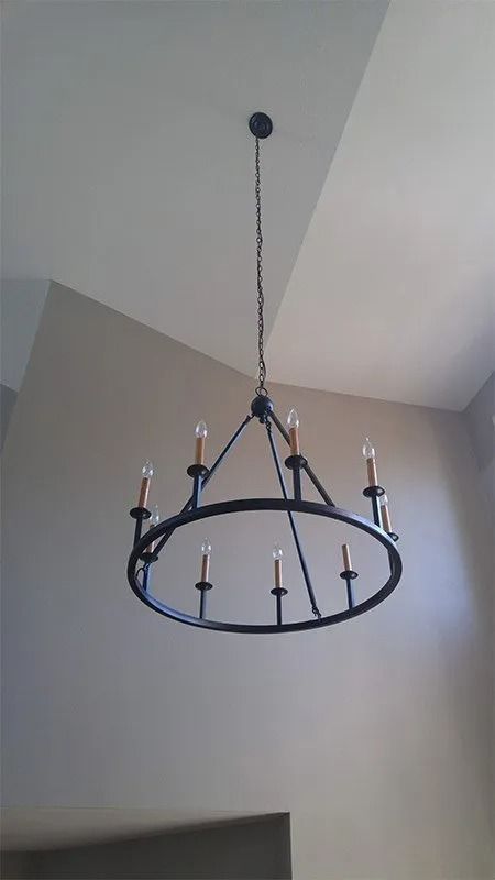 A chandelier is hanging from the ceiling in a room.