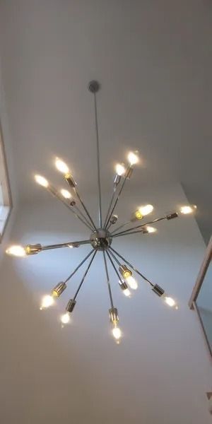 A large chandelier is hanging from the ceiling in a room.