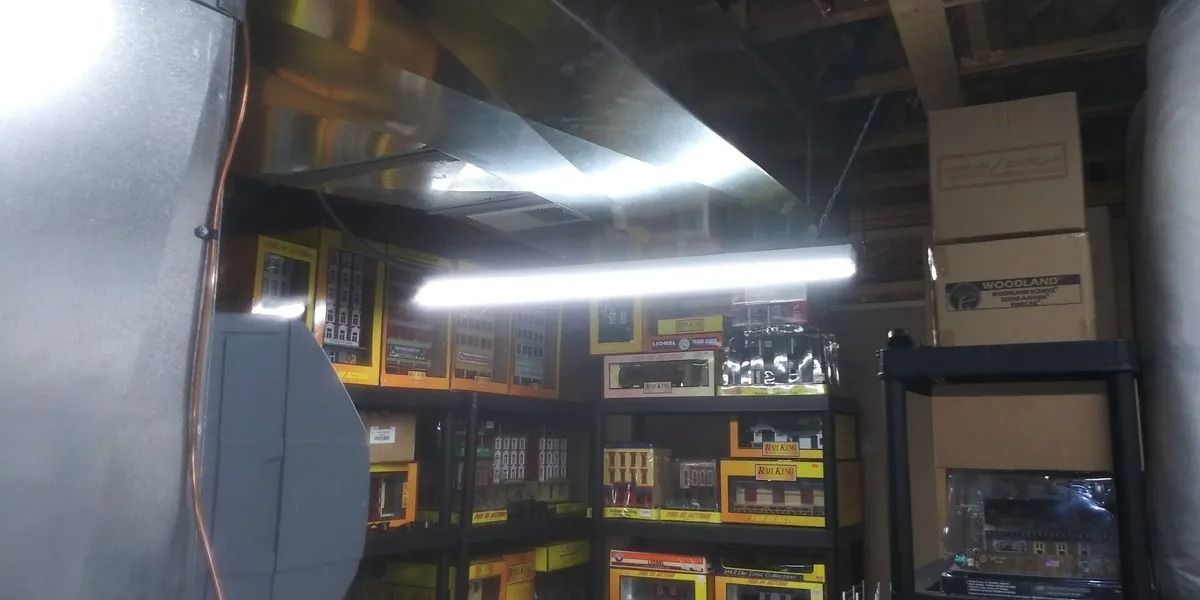 A warehouse filled with lots of boxes and a light hanging from the ceiling.