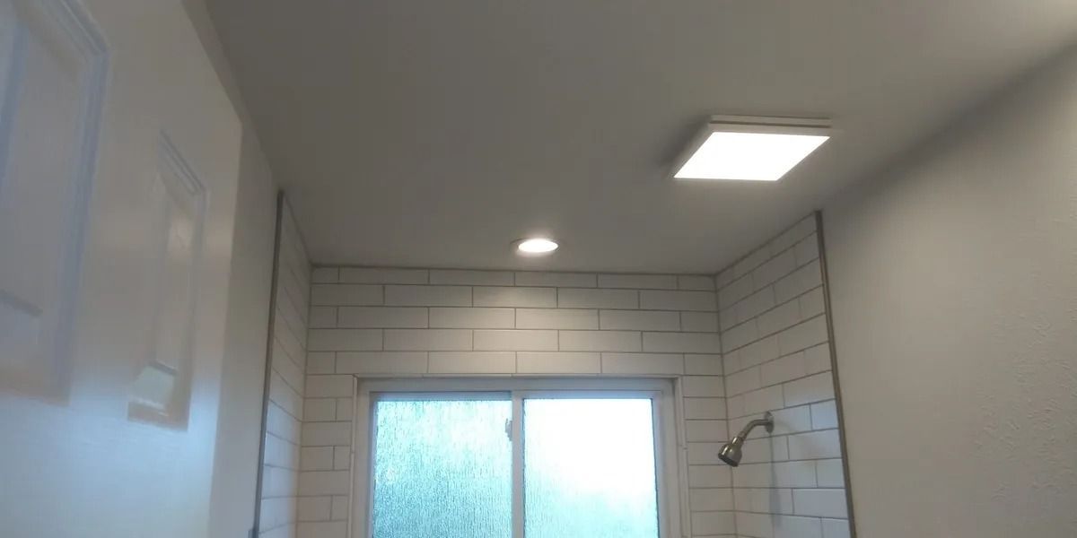 A bathroom with a shower and a window.