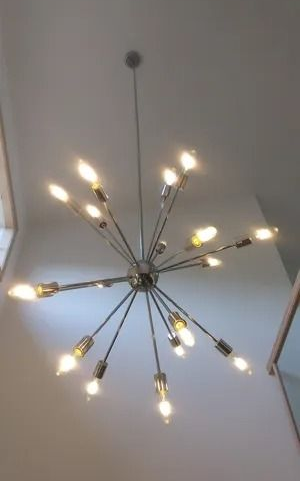 A large chandelier is hanging from the ceiling in a room.