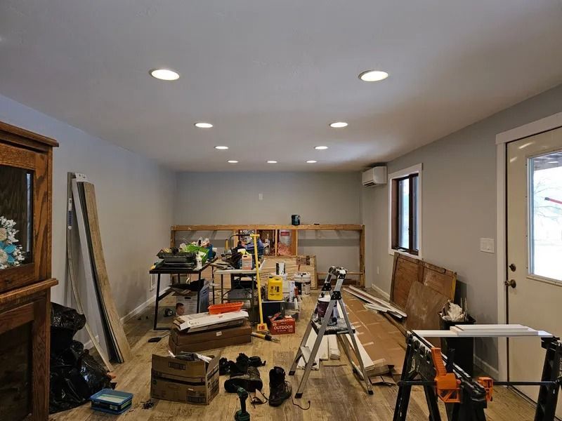 A room with a lot of tools and boxes on the floor.