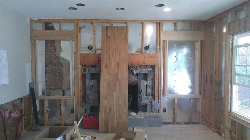 A room that is being remodeled with wooden walls and a fireplace.