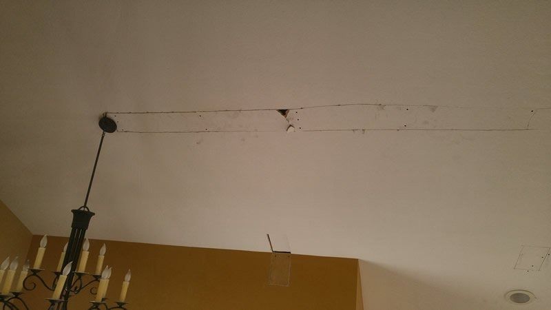 A chandelier is hanging from the ceiling of a room.