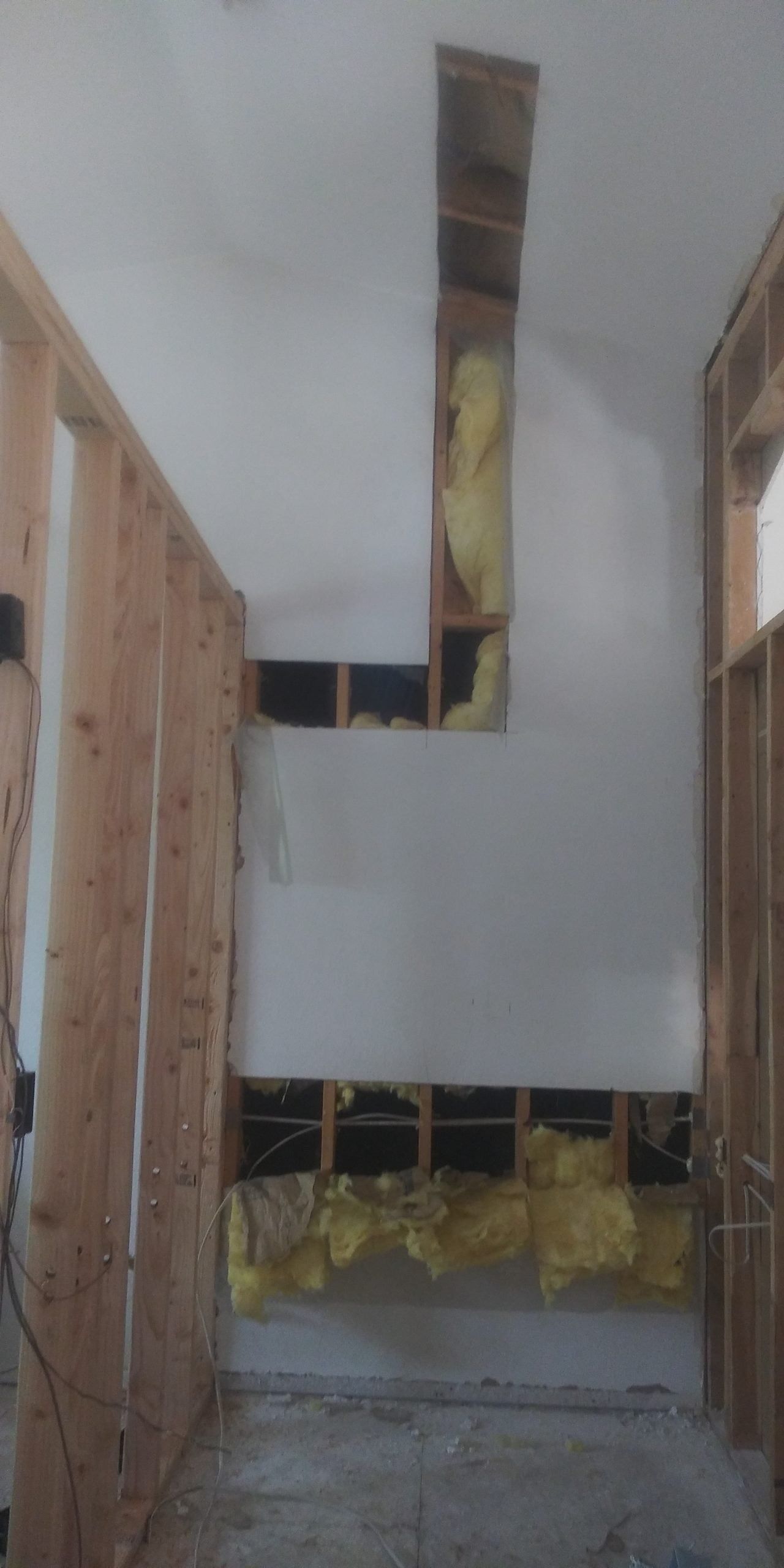 A room with wooden walls and a ceiling that is being remodeled.