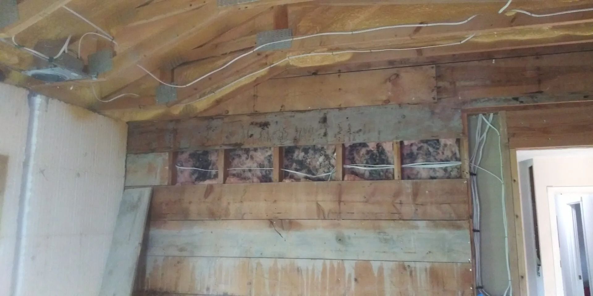A room with a wooden wall and a ceiling.