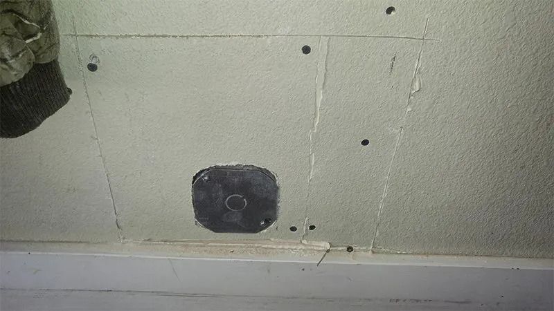 There is a hole in the wall that looks like a hole in the ceiling.