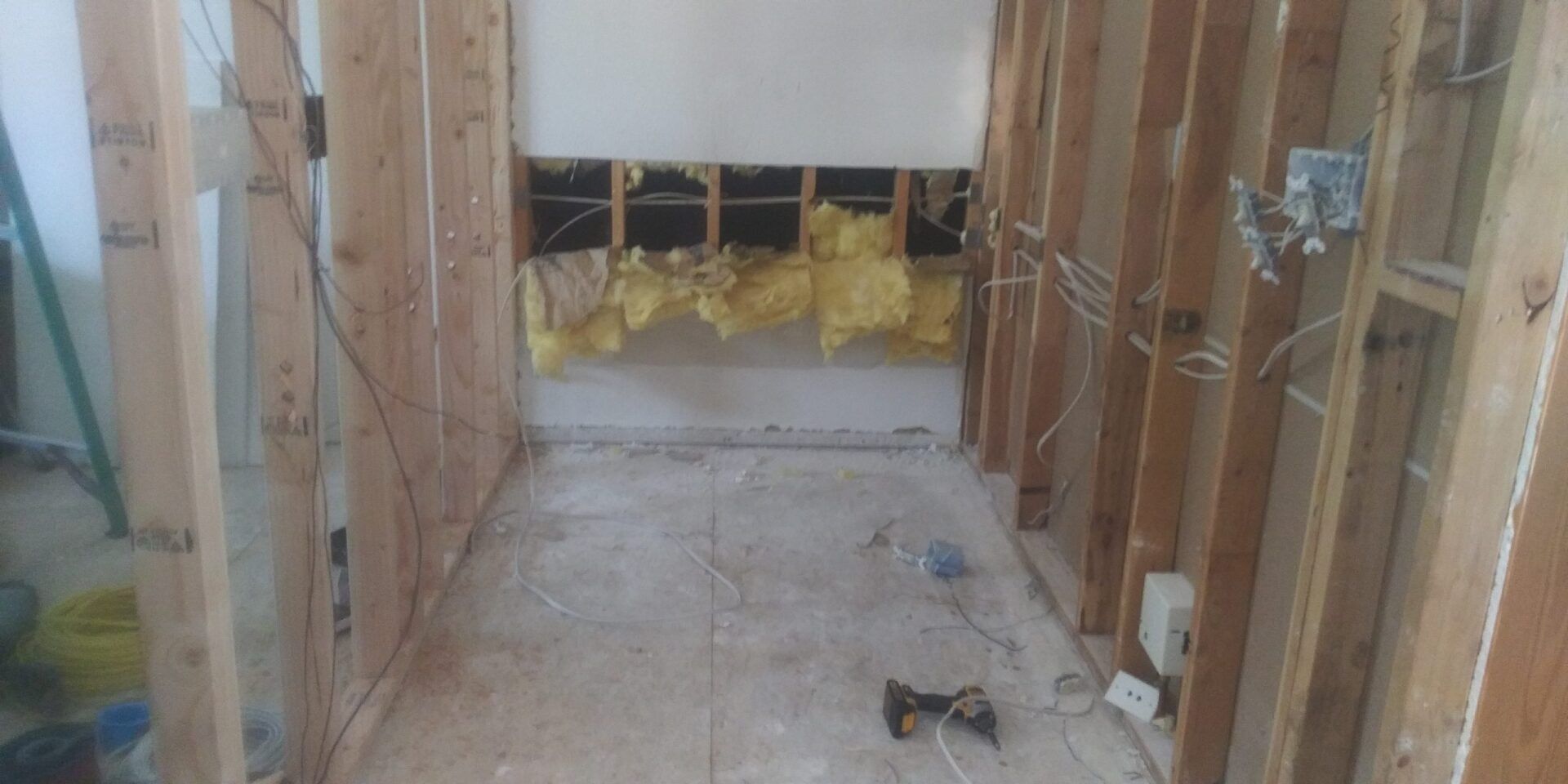 A room with wooden walls and a ladder in it.