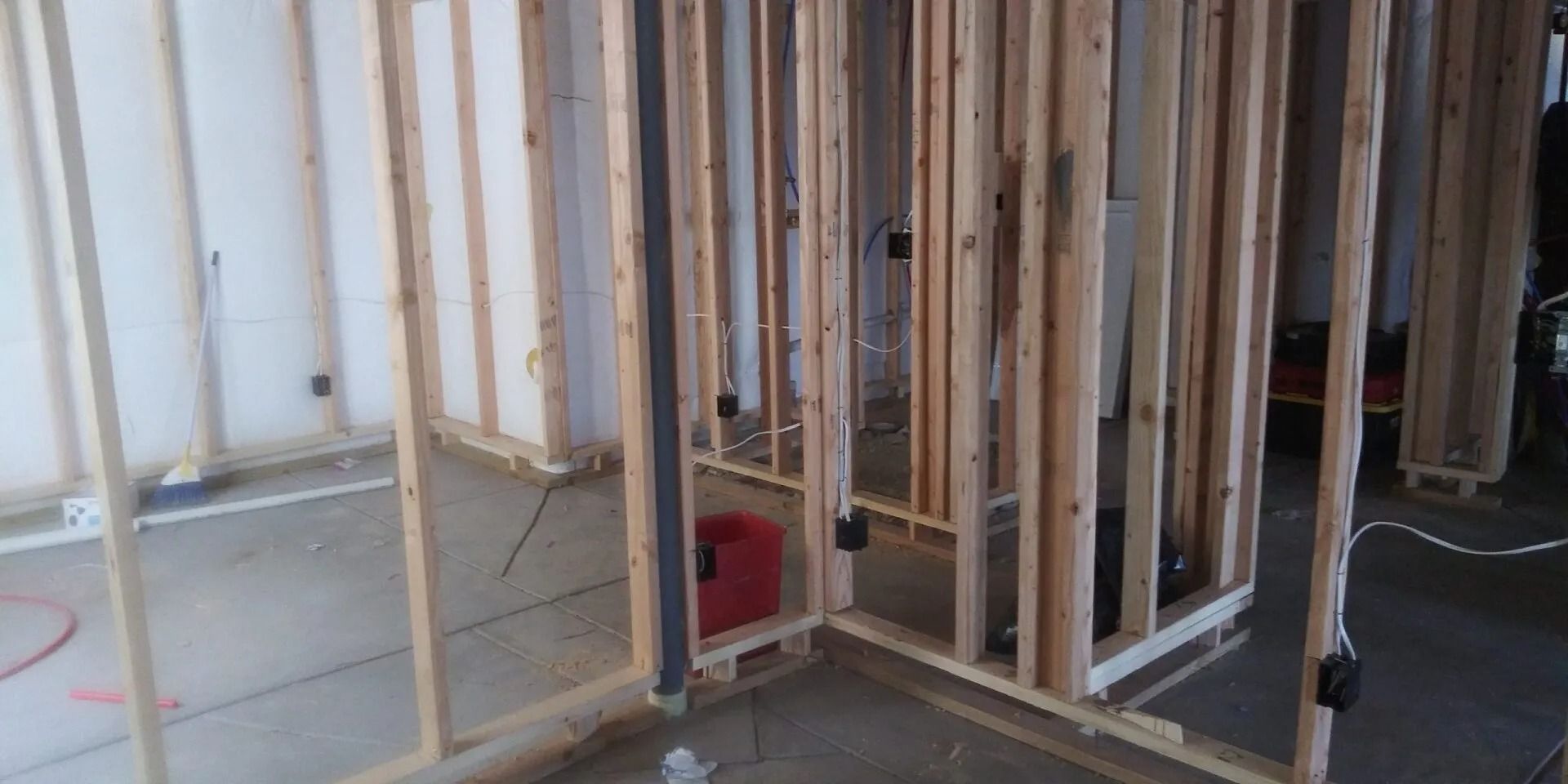 A room is being built with wooden beams and a vacuum cleaner.