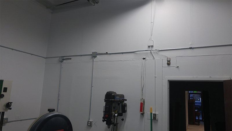 A machine is hanging on a wall in a room.