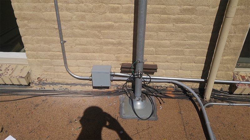 A brick wall with electrical wires attached to it
