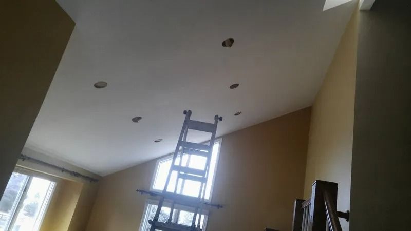 A ladder is hanging from the ceiling of a room.