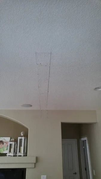 A living room with a white ceiling and a fireplace.