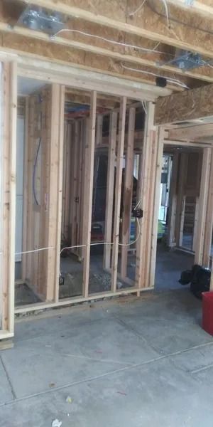 A room with a lot of wooden walls and a concrete floor.