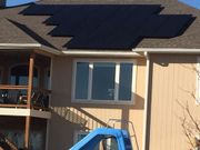 A house with a slide and solar panels on the roof.