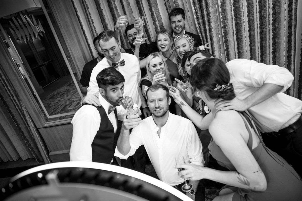 A bride and groom are dancing under a tent at their wedding reception.