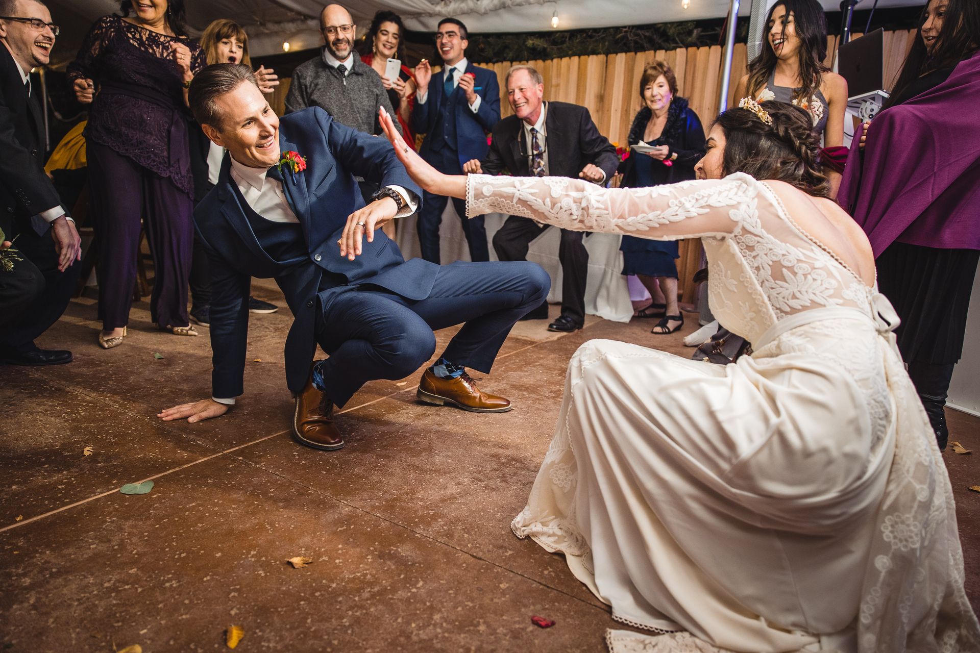 A bride and groom are dancing on a dance floor at their wedding reception.