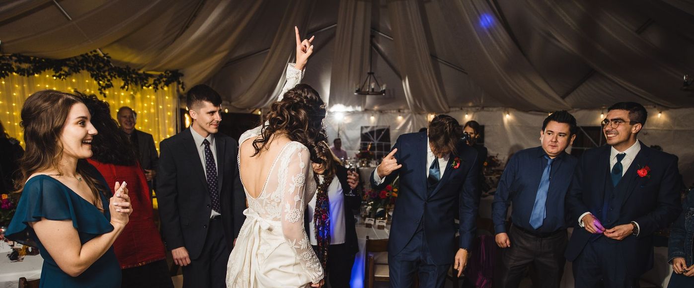 A bride and groom rocking out at their wedding