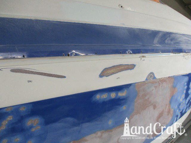 Wellcraft boat in process of exterior fiberglass and gelcoat repair