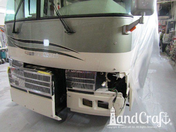 Country Coach motor coach with front end damage in the repair process