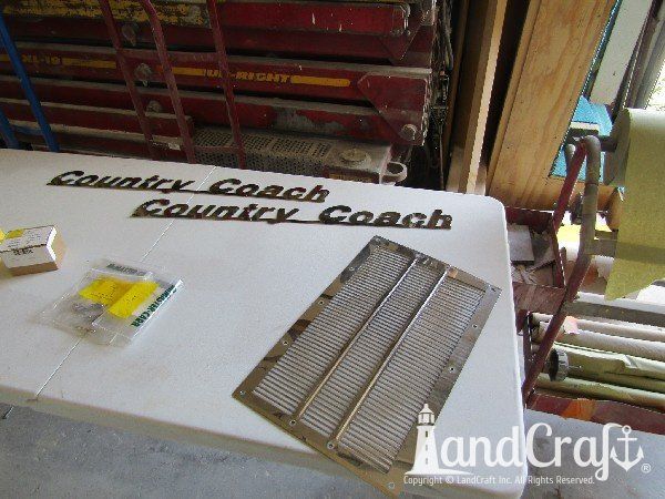 Country Coach motor coach with front end damage in the repair process