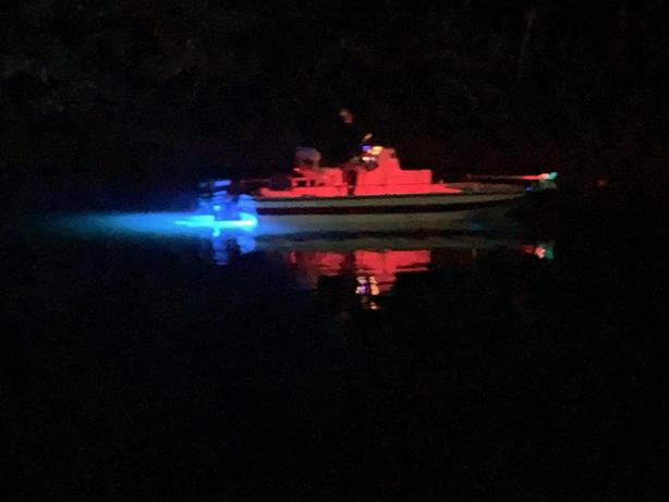 Spirit boat at night with lights on in the water