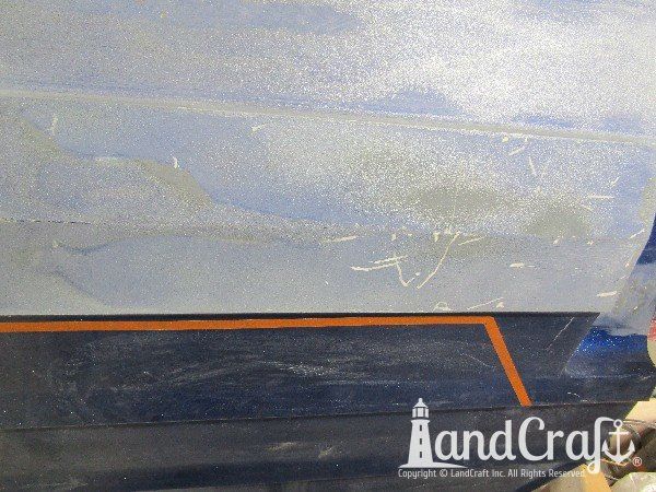 Legend boat with multiple areas of bottom damage that is getting repaired