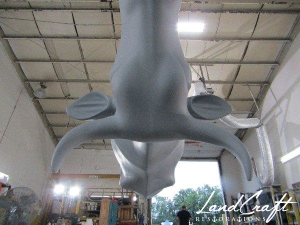 Top Cow art piece statue in the paint refinishing process