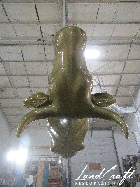 Top Cow art piece statue in the paint refinishing process