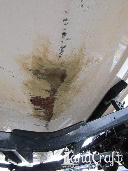 Grounding damage on the bottom of a fiberglass Bryant boat