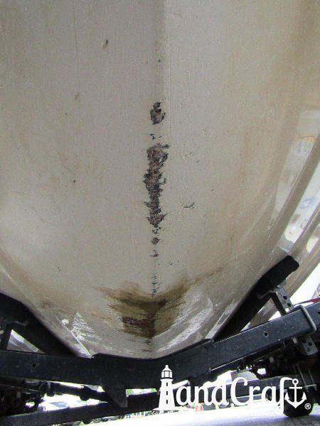 Grounding damage on the bottom of a fiberglass Bryant boat