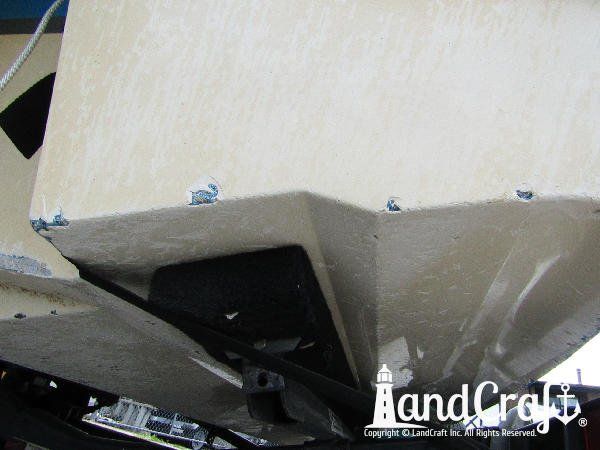 Grounding damage along the bottom of a fiberglass Bryant boat