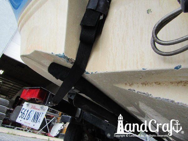 Grounding damage along the bottom of a fiberglass Bryant boat