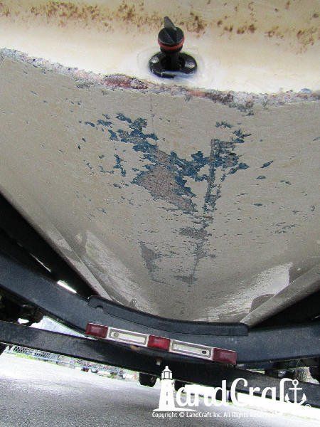 Grounding damage along the bottom of a fiberglass Bryant boat