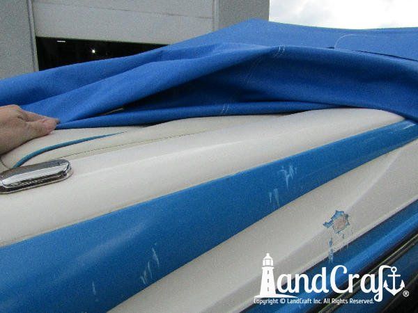 Accident damage along the side of a fiberglass Bryant boat