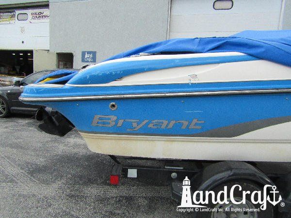 Accident damage along the side of a fiberglass Bryant boat