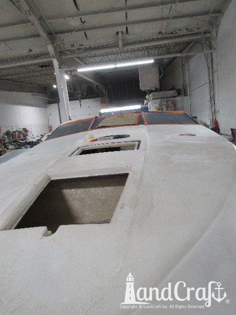 Wellcraft boat in process of exterior fiberglass and gelcoat repair